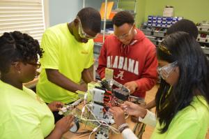SR1 high school scholars are grouped together while they build their robot for the Mississippi First Robotics Competition