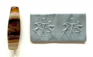 Achaemenid cylinder seal, circa 450-350 BCE, banded agate of a convex shape, carved in the "cut style", depicting an Achaemenid king holding off a stag, 48 mm x 14 mm (est. $500-$900).