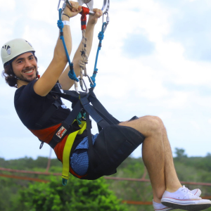 man on a zipline at Selvatica Riviera Maya