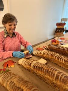 Barbra, another Inspīr resident, makes sandwiches for the Community Fridge.