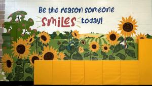 "Be the Reason Someone Smiles Today" on the new school mural