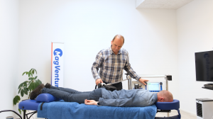 MagVenture Pain Therapy Treatment session. Patient on table with treatment coil over lower back.