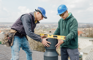 Two men working on chimney repairs.