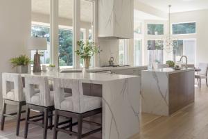 Wendy Glaister Interiors created this stunning modern open concept kitchen with 800 pound custom quartz hood providing drama and waterfall counters lend cohesi-on to the island and peninsula.