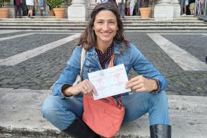 Alejandra Gonzalez shows the Pilgrimage Credential of the Way of the Holy Grail in front of the Papal Basilica of Santa Maria Maggiore