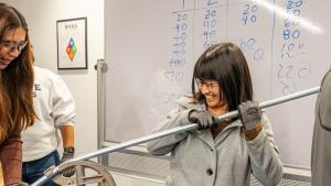 A young women from Loudoun County learns to bend a conduit pipe