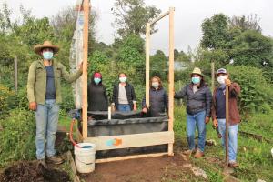 Image shows members of Espacio de Encuentro de las Culturas Originarias in a vegetable garden.