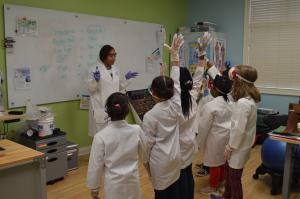 Students attentively engaged with their instructor before diving into an interactive science lesson.