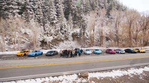 Fast Lane Drive members reunite in Utah, showcasing their luxurious cars in the background.