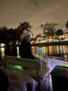 Female guest enjoying the lights, sounds and flavors on Original Orlando Tours' Winter Park Old Fashioned Christmas Cruise