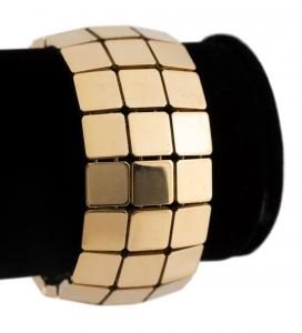 Circa 2002 Tiffany & Co. 18k yellow gold “Tiffany Squares” wide bracelet having three rows of repeating squares with a mirror like finish, in a Tiffany & Company clam shell box ($15,370).