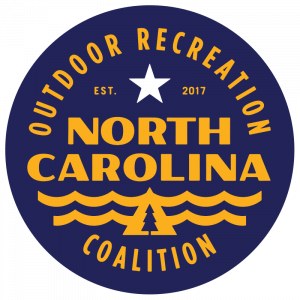 The logo of the North Carolina Outdoor Recreation Coalition, a circle filled with dark blue and yellow lettering using a retro font