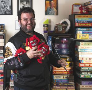 Adam Nedeff proudly displays his game show memorabilia collection, including a fistful of Whammys from "Press Your Luck" plus a microphone befitting a game show lover