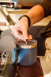 Yeti Rambler 14 oz mug with French Press attachment being used in a car