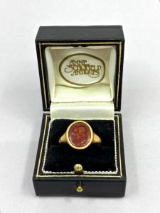 1st Century BCE Roman carnelian intaglio of Jupiter-Annon, with a god’s head in profile facing left, in a later hallmarked 18k yellow gold ring ($5,446).