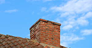Outside view of a roof and chimney.