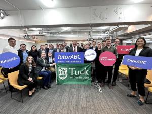 Students and Company CEO hold TutorABC Logo and pose for photos.