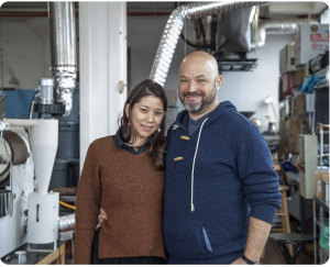 Keith and Mariko Perry, founders of Impresso Coffee, stand in a kitchen-like room