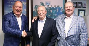 “Now, it’s over to the Joneses,” says Mike Martino. Pictured, left to right, Bryan Kilby, co-owner of Jones Junction, Mike Martino and Danny Jones, co-owner of Jones Junction, celebrating Mike Martino selling his last automotive property in Harford County