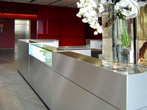 Reception desk finished in a satin polished aluminium plate