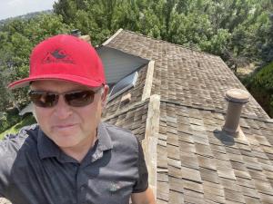 man on top of roof taking a selfie