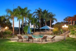 Outdoor amenities within San Diego House include a backyard pool, barbecue area, grass fields and sitting area.