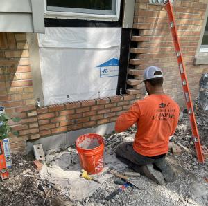 Guy doing masonry work on residential building