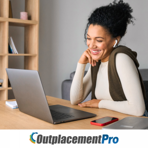 A person with earbuds looking at their laptop and smiling. OutplacementPro logo with white background on the bottom of the image.
