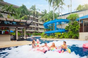 A cheerful family engaging in activities by the pool, surrounded by the resort's tropical landscape, offering a perfect blend of relaxation and fun-filled moments in Phuket, Thailand.