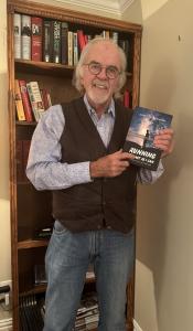 Author John Graham displaying his Book - Running as Fast as I Can