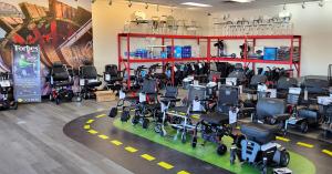 Photo of the showroom with scooters, wheelchairs, collators and the signature test track for getting familiar with the equipment features.