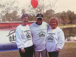 Founders & Former Executive Director of Thomas House Family Shelter smiling at charity walk event in Garden Grove park, wearing event sweatshirts with logo