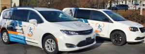 Express Care Transport LLC Vans with wrapped advertising and contact information on the side of the van.