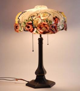 Early 20th century Pairpoint Puffy Papillion table lamp depicting yellow butterflies and red roses in the Papillion pattern over a two-light lamp, marked (est. $800-$1,200).