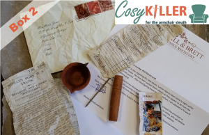 Box two of cosykiller contains a folded cigarette card, letter, burned diya, and some other intreguing objects