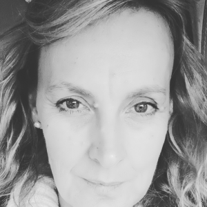 Black and white portrait of Lisa Martin-Pope, a middle-aged woman with a gentle expression, looking directly into the camera, symbolizing the personal strength shared in her memoir.