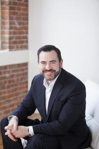 Chris Ochs, Chief Development Officer, Kerico N.E.M.T. services seated in his office.