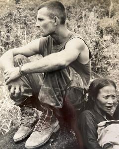 Photo taken during Vietnam War, US Marine about to evacuate POWs