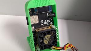 The Bitaxe in a Green Bitaxe Stand v2