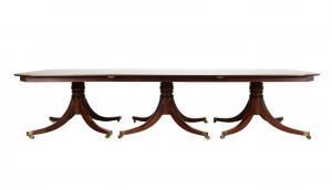 English three-part oblong mahogany dining table in the Georgian taste by William Priest (English, 19th century), 132 inches wide, having a reeded top and triple turned pedestals ($7,865).