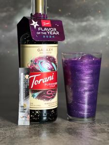 purple glitter drink next to a torani bottle product