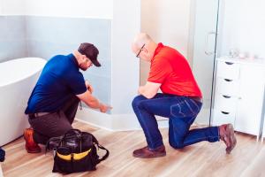 pure maintenance mold remediation technician with customer conducting mold inspection in bathroom in jacksonvile beach beach, florida