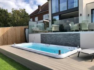 Picture of a Wellis swim spa for sale installed in a deck.