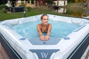 Image of a woman enjoying her new luxury hot tub by Wellis.