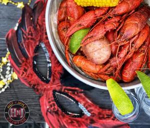 Mardi Gras Mask by a Plate of Crawfish