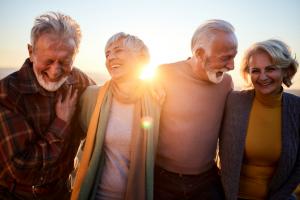 group of older adults walking together in the sunshine