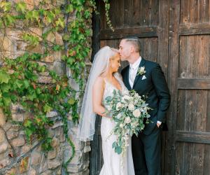 Couple in front of beautiful wooden doors at Winchester Estate by Wedgewood Weddings