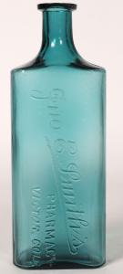 John E. Smith’s Pharmacy (Victor, Colo.) 32-ounce drug store bottle, a stunningly beautiful teal example from the Ron Reed collection, 10 ½ inches tall ($6,250).