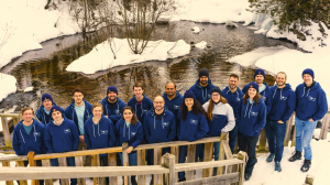The entire company's team of researchers and staff pose by the pond in the snow while celebrating this milestone in quantum error-correction