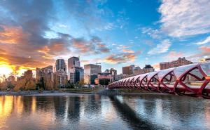 The skyline of Calgary, Alberta, Canada at sunset with the Peace Bridge in the foreground. Calgary is home to software company Truly Legit, which provides intelligent trust badges for websites.